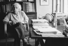 Einstein sitting at his desk
