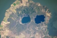 A satellite photo of a rounded peninsula in a lake, with two eye-like lakes at its center