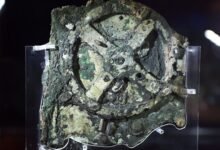 A photo of the corroded Antikythera mechanism in a museum