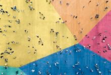 a bird's eye view of a crowd of people on a multicolored floor