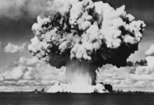 A black and white photo of a large mushroom cloud from a nuclear blast