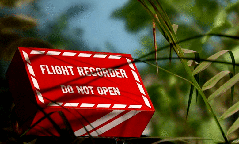 ما الذي تسجله الصناديق السوداء على الطائرات مثل الطائرات والمروحيات؟ 1 an airplane black box hidden by some plants