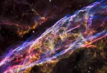 the remnants of a supernova explosion in outer space with rainbow swirling clouds