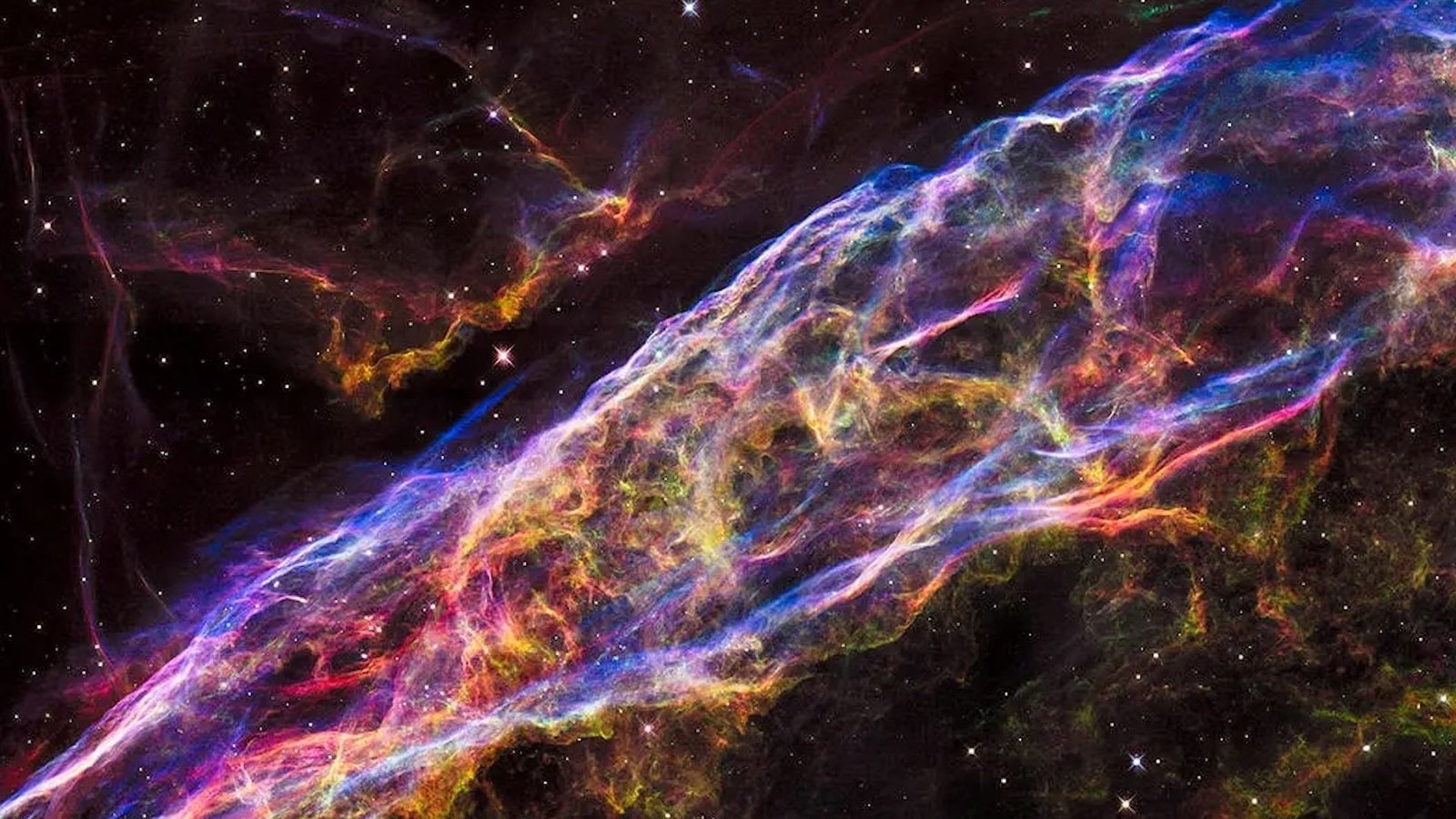 من أين تأتي الذرات؟ يشرح أحد علماء الفيزياء. 6 the remnants of a supernova explosion in outer space with rainbow swirling clouds