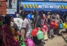 Residents wait in line to fill pots from a water truck in Chennai, India, on Thursday, July 4, 2019.